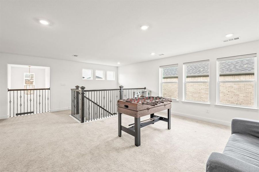 Playroom with light colored carpet and recessed lighting