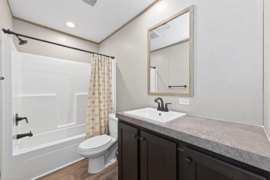 Full secondary bathroom featuring a clean layout with tub/shower combination and modern finishes Full secondary bathroom featuring a clean layout with tub/shower combination and modern finishes