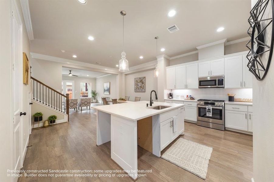 Culinary Excellence: Centered around a generous kitchen island, this modern chef's paradise boasts the latest in sleek stainless steel appliances from LG or Bosch, marrying function with sophistication.