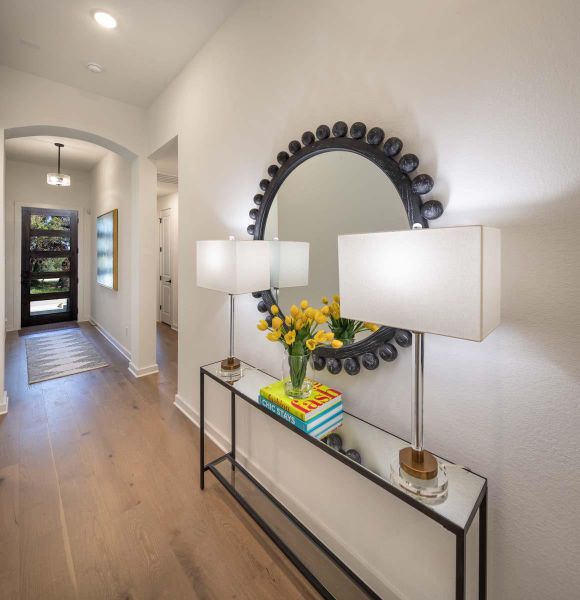 Entryway featuring wood finished floors, arched walkways, and baseboards