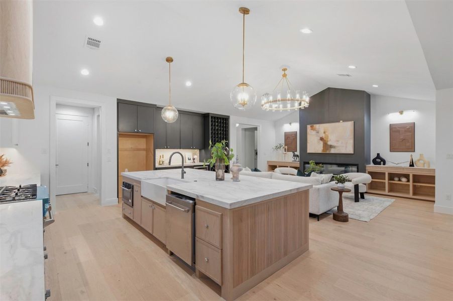 Under-cabinet lighting adds both function and ambiance, beautifully illuminating the countertops and creating a warm glow in the evenings.