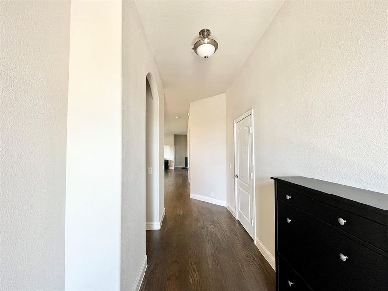 Hallway with dark hardwood / wood-style flooring