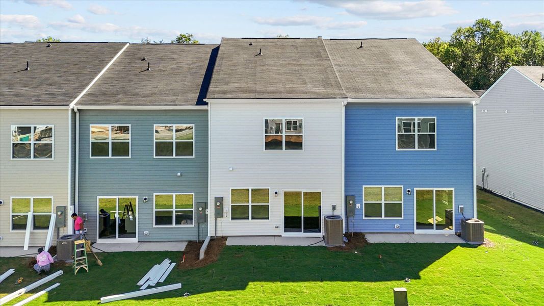 Exterior details and patio area of a home in West Main Townhomes, Sanford (Image 4).