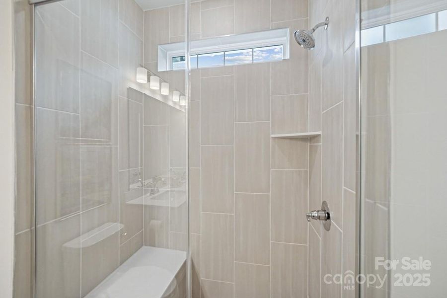 Primary Suite Shower with Floor to Ceiling Tile & Bench Primary Suite Shower with Floor to Ceiling Tile & Bench