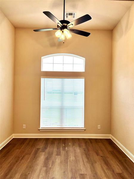 Spare room featuring a ceiling fan, dark wood finished floors, and baseboards Spare room featuring a ceiling fan, dark wood finished floors, and baseboards