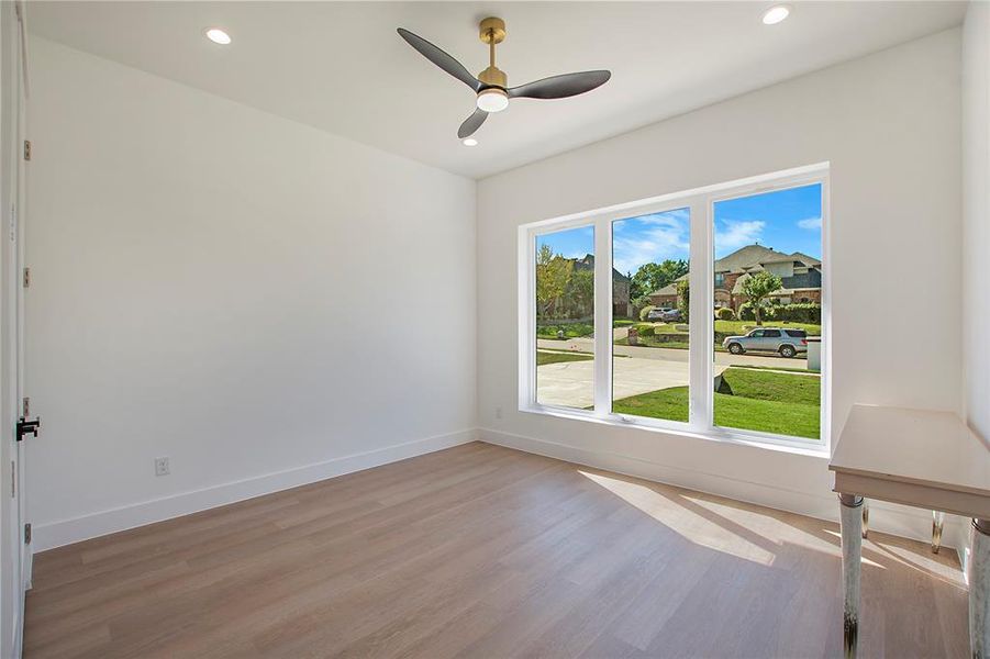 Spare room with ceiling fan and light hardwood / wood-style floors