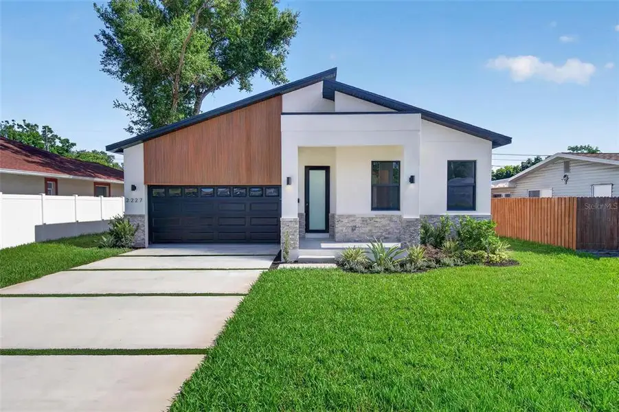 Front exterior of a new home in , St. Petersburg, FL, highlighting curb appeal (Image 1). Front exterior of a new home in , St. Petersburg, FL, highlighting curb appeal (Image 1).