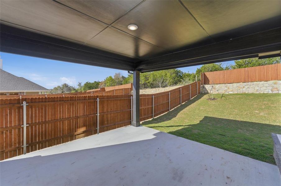 Fenced backyard featuring a patio area