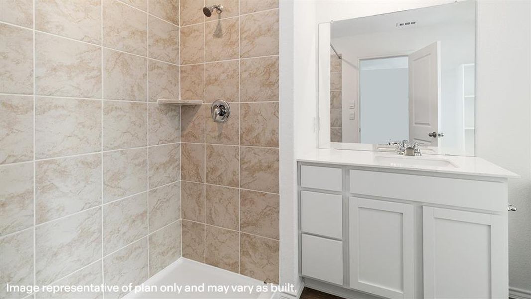 Full bathroom featuring vanity and a tile shower