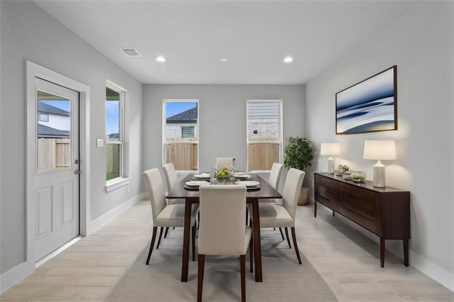 Make memories gathered around the table with your family and friends! This dining room features high ceilings, recessed lighting, large windows, and beautiful tile flooring!