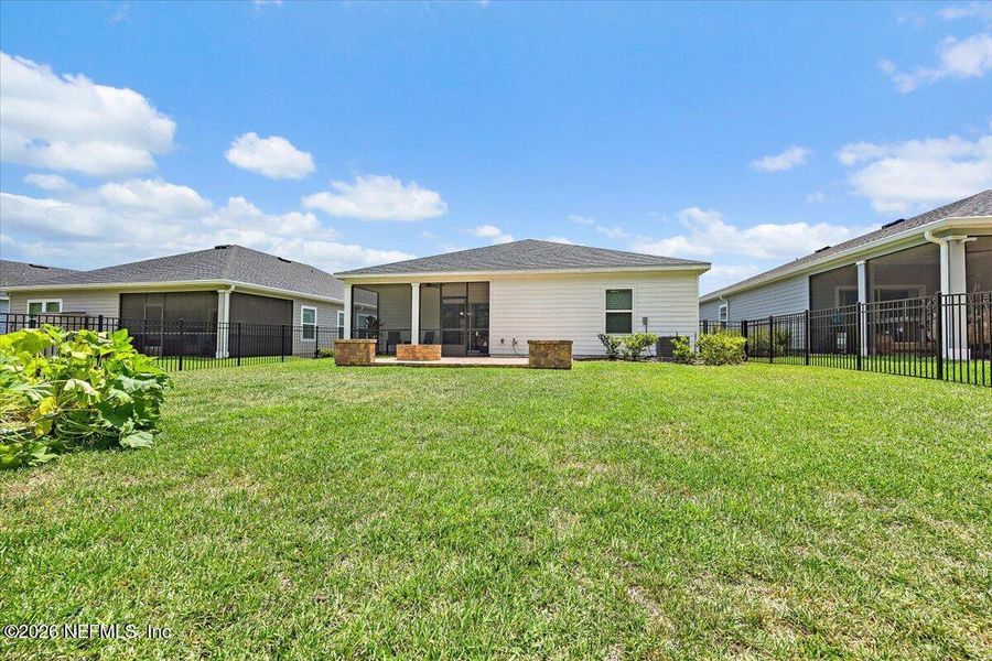 Exterior details and patio area of a home in Edenbrooke at Hyland Trail | 55+, Green Cove Springs (Image 18).