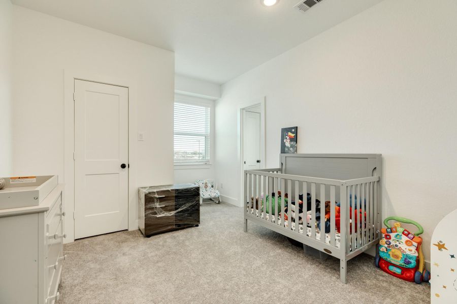 Secondary bedroom with well-maintained carpet; shares Jack and Jill bath.