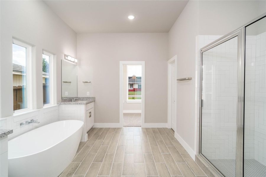 Large primary en-suite bath with double sinks, soaking tub and separate shower Large primary en-suite bath with double sinks, soaking tub and separate shower