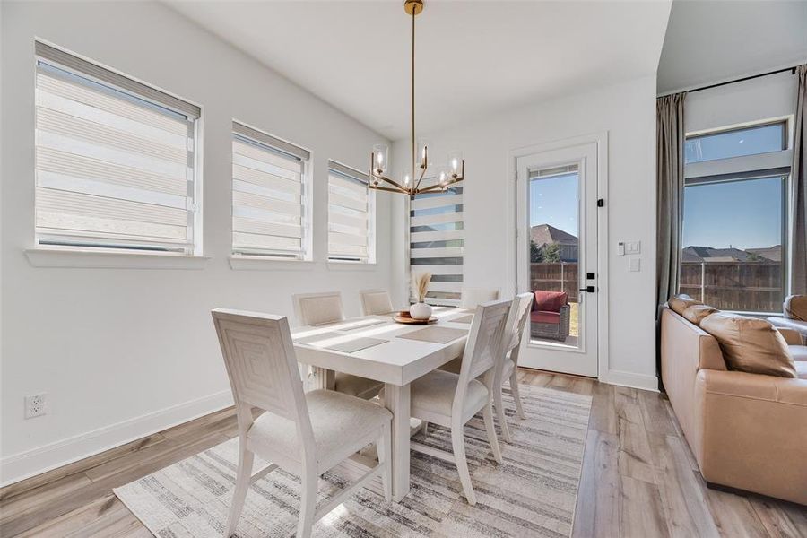 Dining room with a chandelier and light wood finished floors