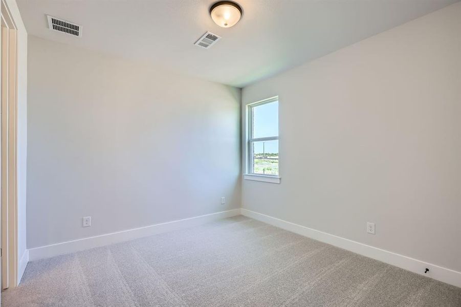 Unfurnished room featuring light colored carpet and baseboards Unfurnished room featuring light colored carpet and baseboards