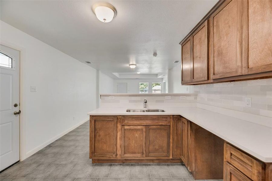 Kitchen featuring sink, plenty of natural light, and kitchen peninsula