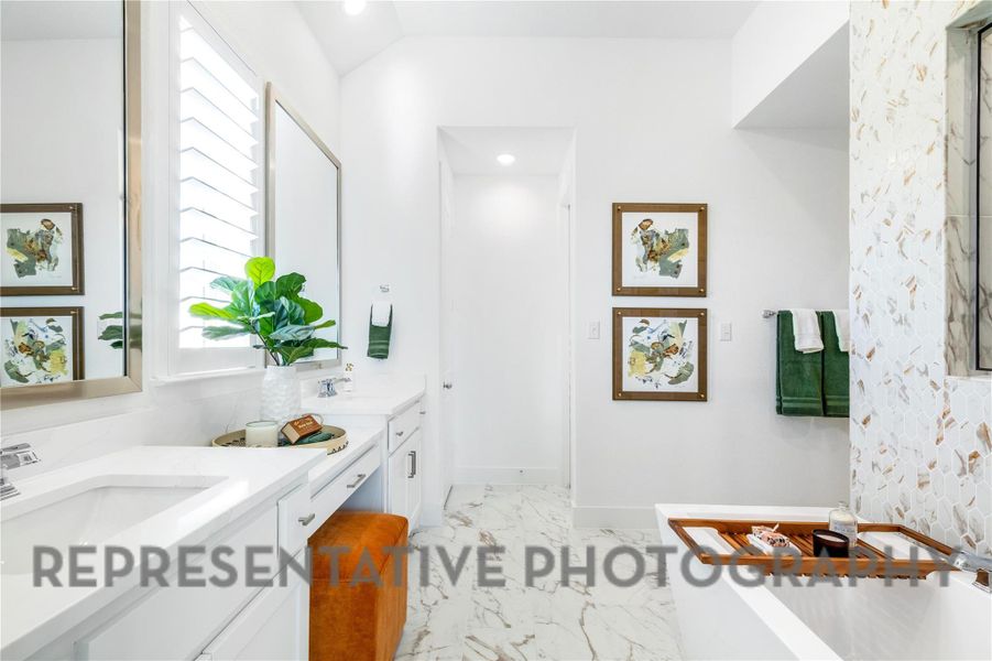 Bathroom featuring vanity, marble finish floor, a freestanding tub, lofted ceiling, and recessed lighting Bathroom featuring vanity, marble finish floor, a freestanding tub, lofted ceiling, and recessed lighting