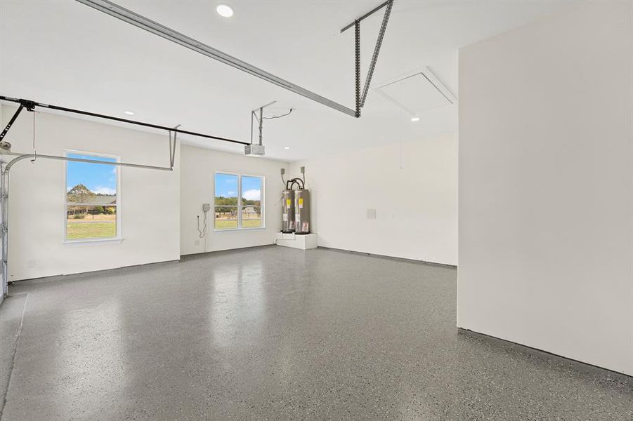 Garage featuring water heater and recessed lighting