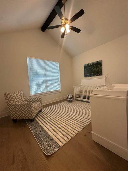 Vaulted ceiling featuring an exposed beam and a ceiling fan