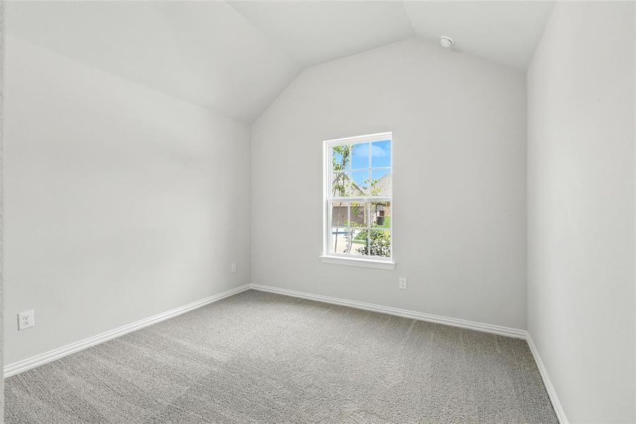 Additional living space featuring light carpet and baseboards