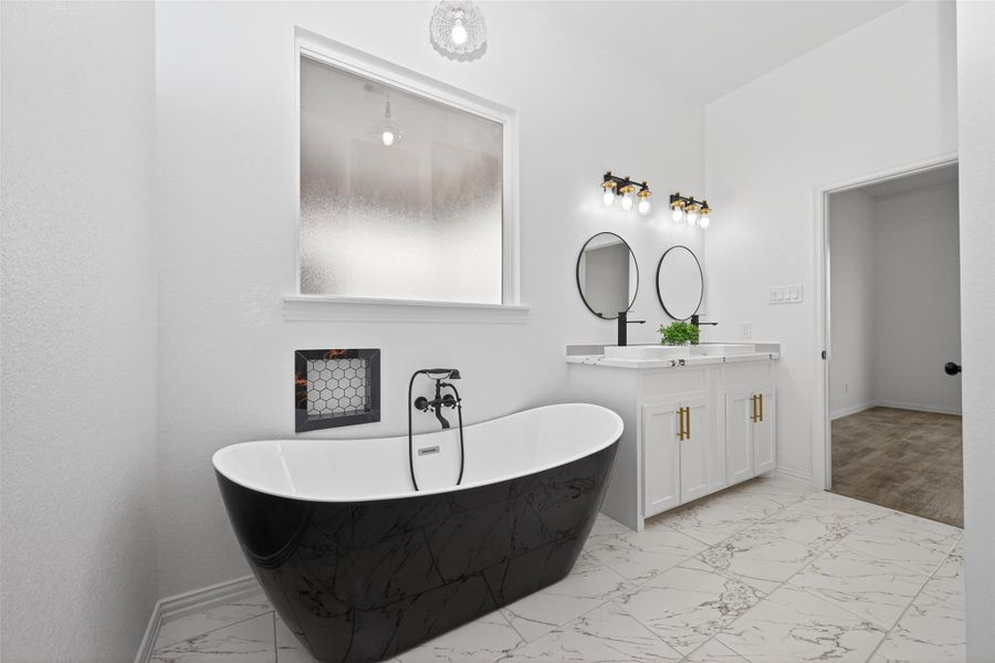 Luxurious ensuite bathroom featuring a soaking tub, walk-in shower, and double-sink vanity.