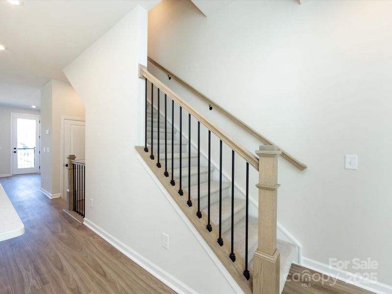 Open Rail Leading to Third Floor Allows a Natural Flow of Light and Elevates the Space.