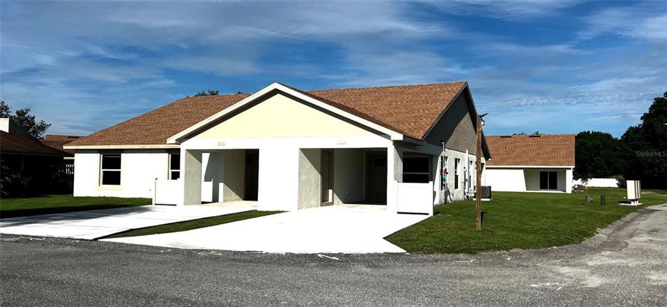 Front exterior of a new home in , Mulberry, FL, highlighting curb appeal (Image 1).