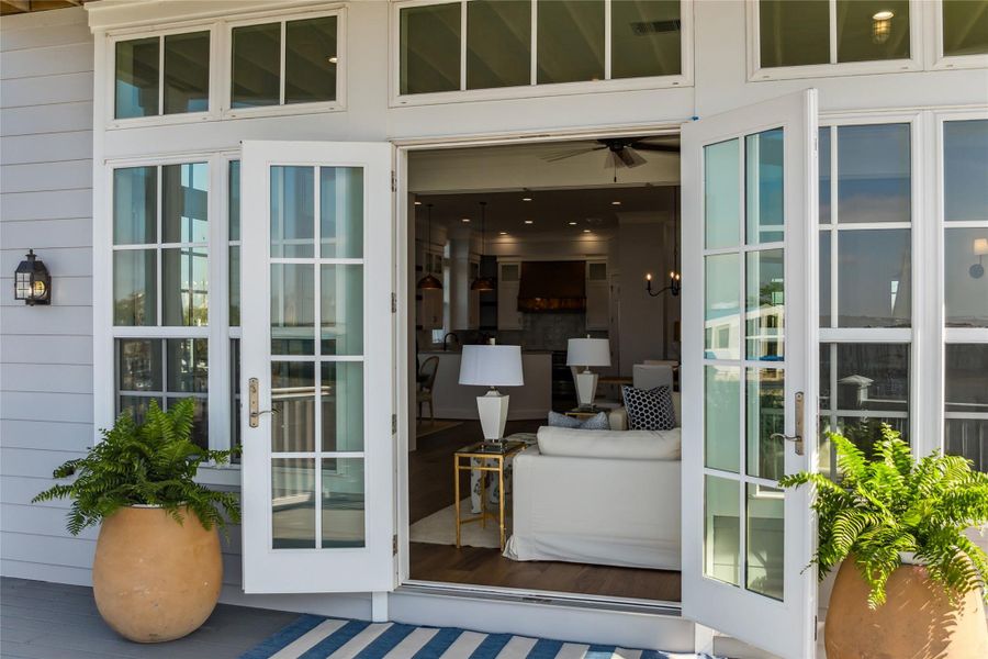 Double doors leading from living room to balcony view. Double doors leading from living room to balcony view.