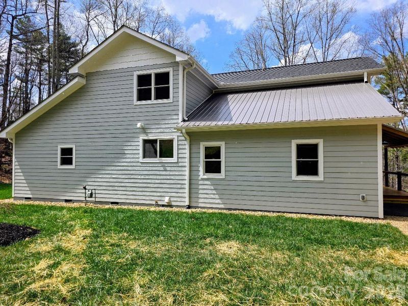 Eastern side of the house with metal roof over garage visible