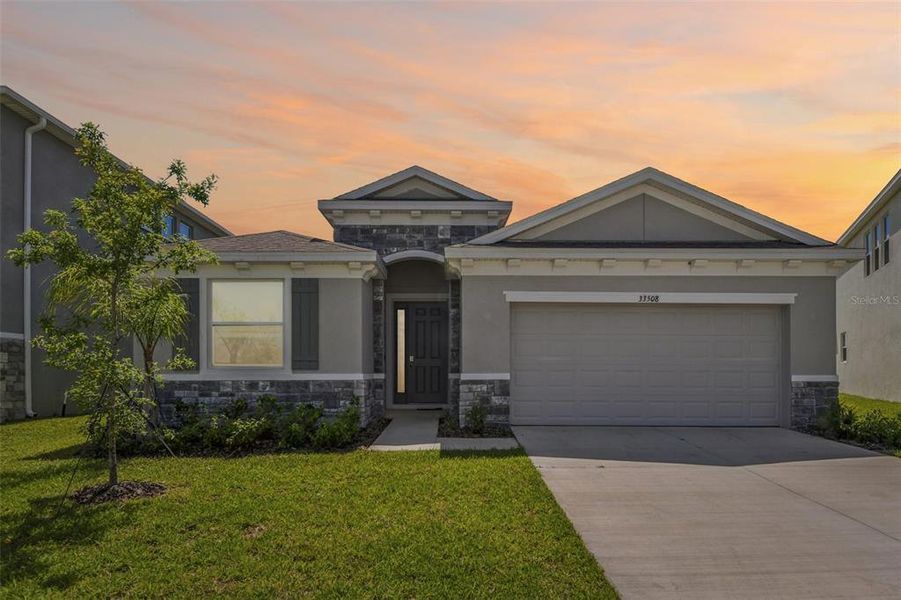 Front exterior of a new home in , Wesley Chapel, FL, highlighting curb appeal (Image 2). Front exterior of a new home in , Wesley Chapel, FL, highlighting curb appeal (Image 2).