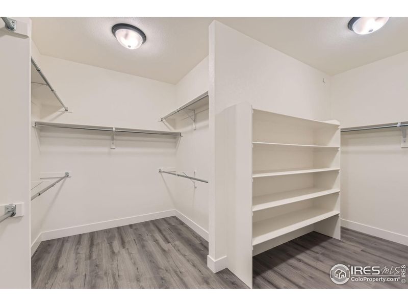 Huge master bedroom walk-in closet with built-in shelves and room for all your clothes and shoes.