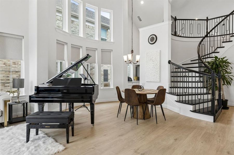 Soaring ceilings complement the light wood-finish flooring
