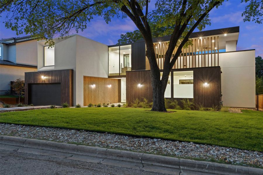 Contemporary house with a garage, a front lawn, stucco siding, concrete driveway, and a balcony Contemporary house with a garage, a front lawn, stucco siding, concrete driveway, and a balcony