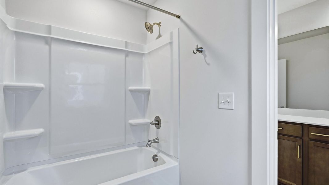 Accomplished full bath designed with both comfort and sophistication in mind by DRB Homes Accomplished full bath designed with both comfort and sophistication in mind by DRB Homes