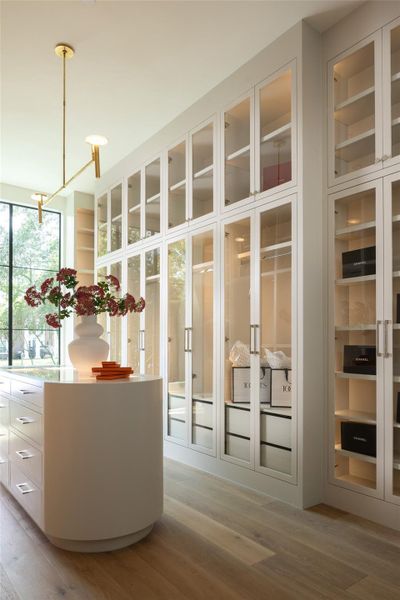A custom glass-front wardrobe room with expansive RAM windows that flood the space with natural light offers a boutique-inspired experience. A custom glass-front wardrobe room with expansive RAM windows that flood the space with natural light offers a boutique-inspired experience.