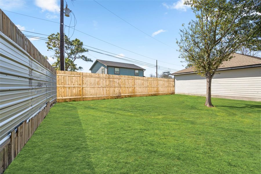Wide, fenced yard provides privacy and room to create your ideal outdoor retreat.