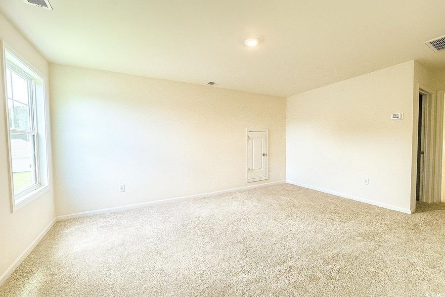 Carpeted spare room featuring baseboards Carpeted spare room featuring baseboards