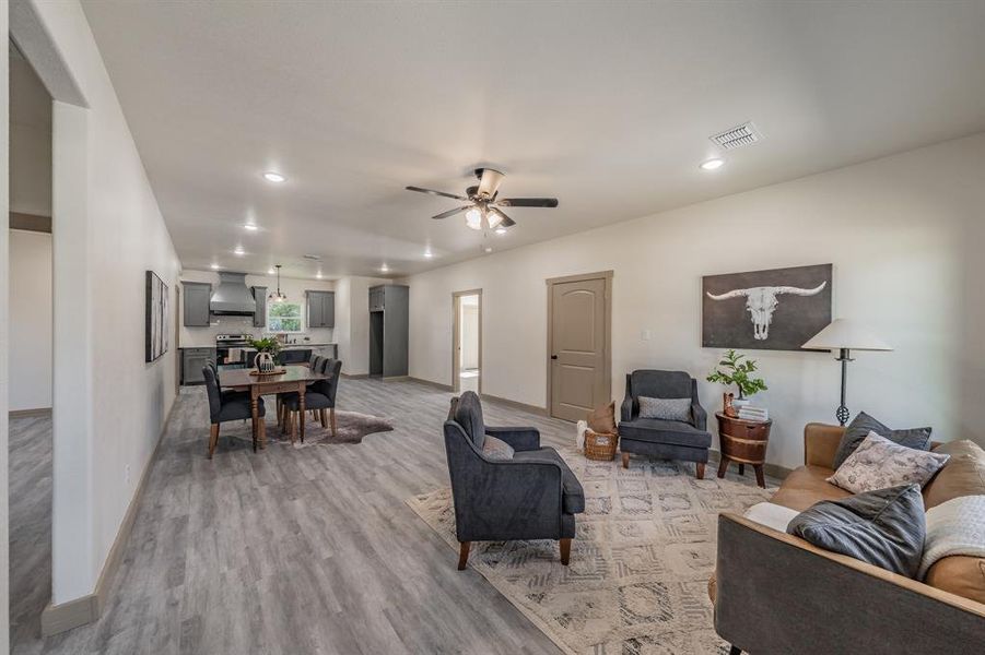Living room featuring recessed lighting, light wood-style floors, and ceiling fan