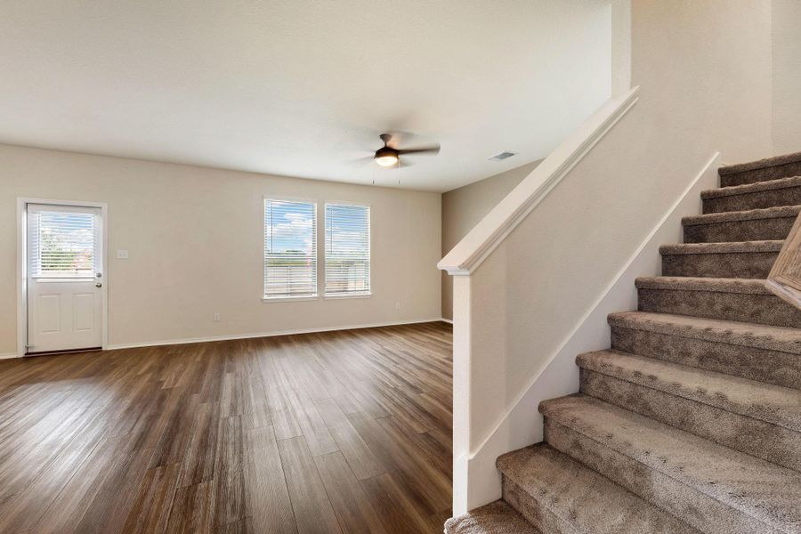 A well-lit living area features warm wood type flooring A well-lit living area features warm wood type flooring