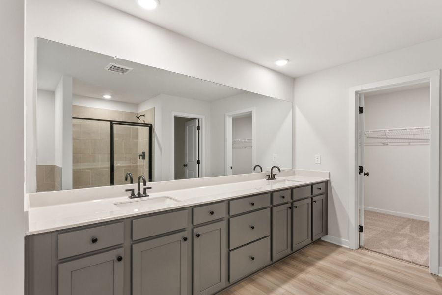 A bathroom with a large mirror.