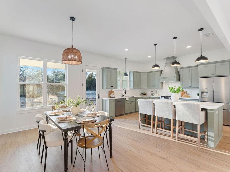 Kitchen featuring stainless steel appliances, light stone counters, and backsplash