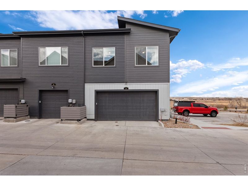 Front exterior of a new home in Whisper Village, Arvada, CO, highlighting curb appeal (Image 2).