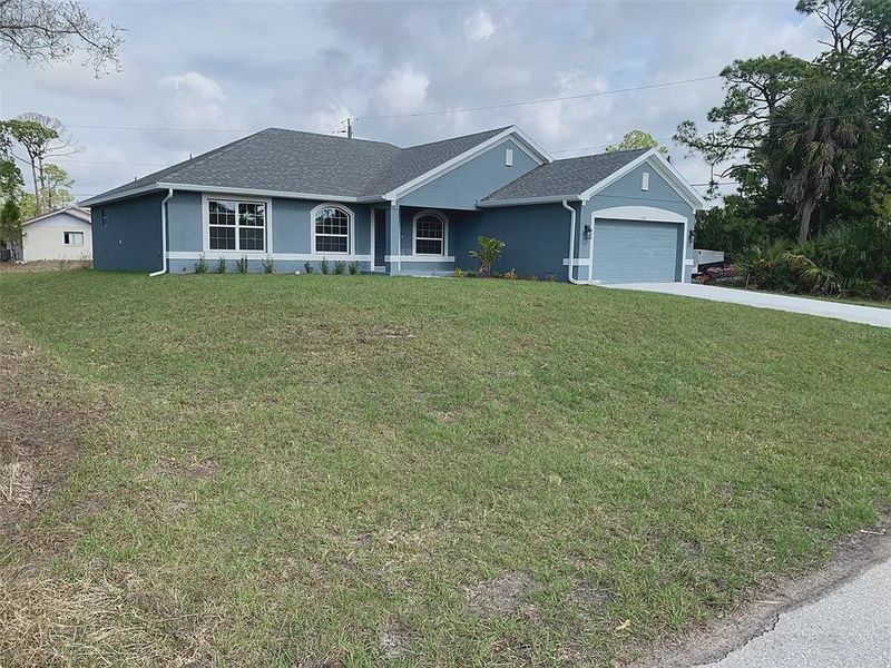 Front exterior of a new home in Gulf Cove, Port Charlotte, FL, highlighting curb appeal (Image 2). Front exterior of a new home in Gulf Cove, Port Charlotte, FL, highlighting curb appeal (Image 2).