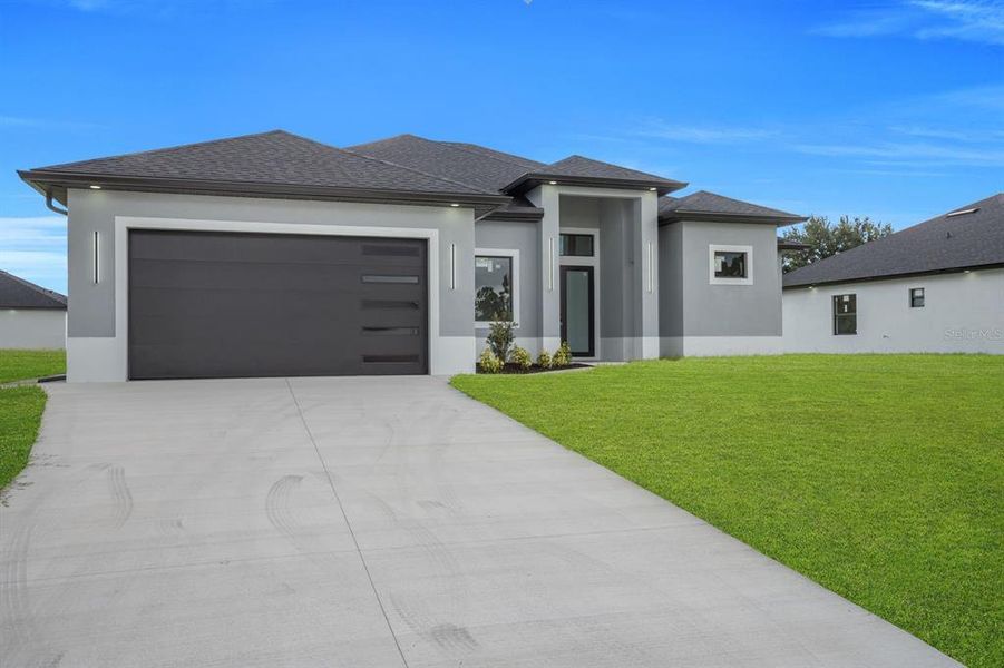 Front exterior of a new home in , Lehigh Acres, FL, highlighting curb appeal (Image 19).