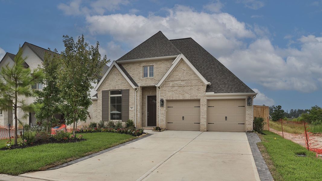 Front exterior of a new home in Grand Central Park 50', Conroe, TX, highlighting curb appeal (Image 1). Front exterior of a new home in Grand Central Park 50', Conroe, TX, highlighting curb appeal (Image 1).