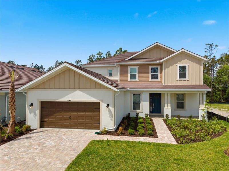 Front exterior of a new home in Hammock at Two Rivers, Zephyrhills, FL, highlighting curb appeal (Image 30).