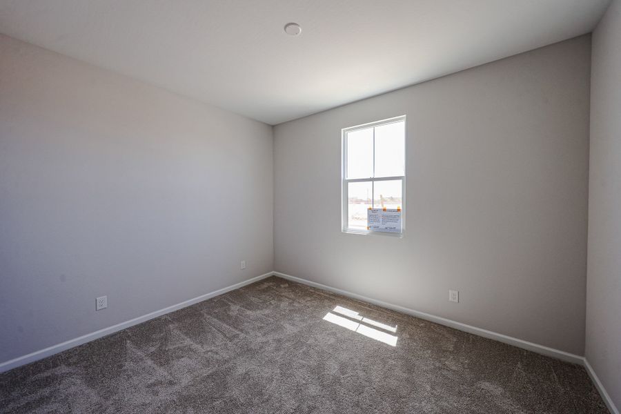 A room with a window and a carpet. A room with a window and a carpet.