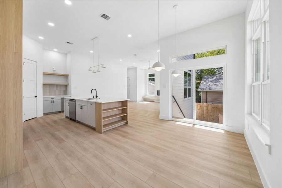Oversized sliding glass doors flood the home with natural light while providing easy access to the covered balcony and backyard below.