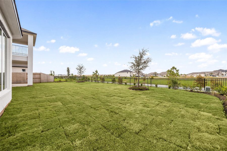 Premium lakefront backyard lot highlighting the exceptional privacy and scenic open views. Secured by high-end black wrought-iron fencing along the rear border, this massive lawn directly overlooks the community lake, walking trails, and neighborhood green spaces. The wide, flat footprint offers an expansive canvas that is completely pool-ready, allowing you to design your dream custom oasis with zero rear neighbors to obstruct the view. Premium lakefront backyard lot highlighting the exceptional privacy and scenic open views. Secured by high-end black wrought-iron fencing along the rear border, this massive lawn directly overlooks the community lake, walking trails, and neighborhood green spaces. The wide, flat footprint offers an expansive canvas that is completely pool-ready, allowing you to design your dream custom oasis with zero rear neighbors to obstruct the view.