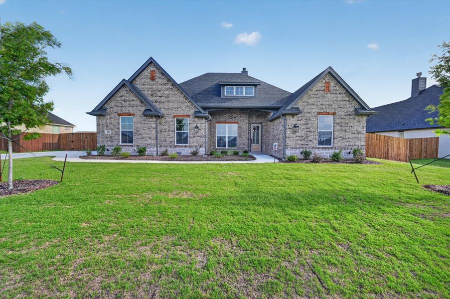 Front exterior of a new home in Coyote Crossing, Godley, TX, highlighting curb appeal (Image 2). Front exterior of a new home in Coyote Crossing, Godley, TX, highlighting curb appeal (Image 2).